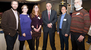 Faculty pose for the camera with President McRobbie